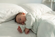 © Kawee - A peaceful baby boy sleeping soundly on bed in cozy bedroom at home.