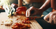 © peopleimages.com - Kitchen, cutting and hands of couple for cooking, cuisine and meal prep for dinner or lunch. Marriage, home and people with knife, vegetables and ingredients for recipe, culinary skills and help