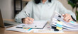 © Smile Studio AP - Business professional reviewing performance reports and auditing stack of documents at office desk. Concept of corporate audit, compliance check, data analysis,