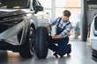 © Serhii - Mechanic installing new tire on vehicle in car service