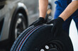 © Serhii - Mechanic handling car tire during automotive service