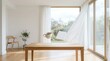 © Katsyarina - Book and teacup hovering above wooden table in airy modern room. Surreal cozy morning scene with floating objects near window with flowing curtain. Interior design and wellness concept.