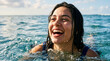 © Len_mik - Joyful young woman emerging from ocean water smiling. Happy female swimmer laughing in the sea on a sunny day
