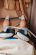 © Mdv Edwards - Anonymous male patient receives a HIFEM body contouring treatment on the buttocks using electromagnetic muscle stimulation applicators in a professional aesthetic clinic.