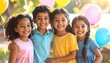 © BERKAH - Four children smiling with colorful balloons.