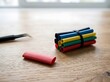© RenderEdge - Heat shrink tubing bundle with tweezers on a wooden surface with natural light for electrical repairs and DIY projects
