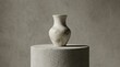© FixelShotpro - Minimalist ceramic vase standing on a textured cimento queimado pedestal against a neutral grey wall for modern interior design and luxury home decor
