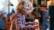 © Suleyman - Boy with blonde hair plays music on piano inside his house.