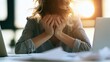 © Aleksandr - Stressed businesswoman suffering from job burnout holding head in hands at office desk