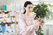 © JackF - Female shopper scans code on toothbrush label to check the expiration date