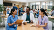 © Wajid Ali - Group of diverse medical professionals talking in hospital cafeteria perfect for highlighting healthcare teamwork and staff collaboration