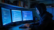 © melghi - Person coding on multiple computer screens