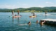 © Nina - Group of diverse friends enjoying summer water sports on a scenic mountain lake with paddleboarding kayaking and water skiing activities