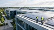 © Thea - Engineers inspecting large solar panel array on modern office building rooftop, illustrating commercial photovoltaic system maintenance, facility management