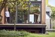 © Westend61 - Thoughtful mature man standing at entrance of tiny house