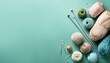 © Samantha - assorted knitting yarn and crochet tools on pastel teal background with copy space