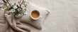 © AkuAku - Rustic linen pillowcase featuring apple blossom branches in vase alongside hot coffee cup in square pillow mockup