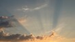 © Alena - Crepuscular rays breaking through dark clouds in evening sky. Beautiful scenic view of sunbeams and dramatic light breaking through soft clouds during golden hour sunset in blue sky