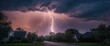 © vxnaghiyev - Lightning striking over a quiet suburban street at dusk