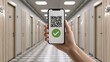 © NickArt - A hand holds a smartphone displaying a QR code with a green check mark on a hallway background. Perfect for technology use.
