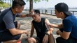 © OlgaNeuroArt - Friends helping an exhausted man after outdoor workout in summer heat. Male athletes providing water and wiping sweat from an overheated runner sitting on the ground