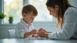 © Victoria - Child and woman sit together at a table