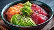 © Muslima - Gourmet chirashi sushi bowl with fresh tuna salmon avocado and seaweed salad.