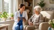© iravgustin - Healthcare worker holding a tablet and consulting a senior person while sitting on a sofa during a friendly home care medical visit.