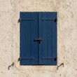 © KIMOG - Old Window with Open Blue Wooden Shutters on Rustic European House Facade