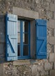© KIMOG - Old Window with Open Blue Wooden Shutters on Rustic European House Facade