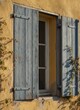 © KIMOG - Old Window with Open Blue Wooden Shutters on Rustic European House Facade