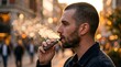© KIMOG - Adult Man Using Electronic Cigarette and Exhaling Vapor Outdoors at Sunset