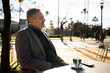 © Nazareno - Mature man enjoying coffee relaxing at outdoor cafe
