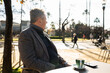 © Nazareno - Mature man relaxing outdoors with coffee contemplation