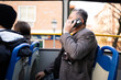 © Nazareno - Man on public bus talking on smartphone