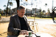 © Nazareno - Mature man enjoying morning coffee outdoors in urban park