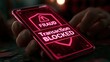 © Oulaphone - A smartphone screen shows a fraud alert warning with a red shield icon, symbolizing cybersecurity and protection against digital threats and scams.