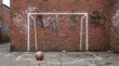 © Sekai - Urban red brick wall featuring a crude chalk drawn goal frame for street football soccer