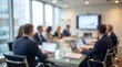 © CuteBee - Blurred professional business team working together during corporate boardroom meeting in modern office space with bright natural light coming through large windows reflecting glass table