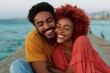 © Iryna - Joyful seaside couple smiling close together for romantic background and lifestyle banner by the ocean