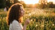 © Candra - Young Woman Blowing Dandelion Seeds in Golden Hour Sunlight.