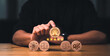 © Kudrat - Hand placing a wooden block with a tree icon on a table for customer service rating and feedback