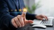 © Ranju - Businessman hand touching five star rating for excellent service in modern office