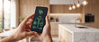 © itlada - Smart home control interface on a smartphone screen, showing energy management with solar power and appliances, set in a modern kitchen for home automation and efficiency