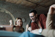 © Novak - Small startup business team working together at office desk