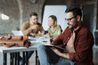 © Novak - Group of diverse business people working together in modern open plan office