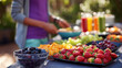 © KotBaton - Fresh berries, grapes and colorful fruit selection on an outdoor buffet table with juices. Healthy eating, balanced nutrition, summer catering, wellness and organic lifestyle concept.