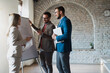 © Novak - Three diverse business people brainstorming and looking at whiteboard