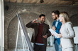 © Novak - Three diverse business people brainstorming and looking at whiteboard