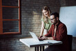 © Novak - Businessman and businesswoman working together on laptop at office desk